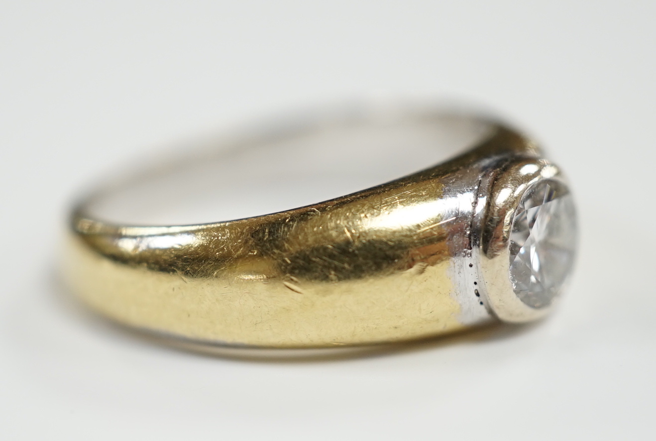 A modern 18ct gold and collet set solitaire diamond ring, size N, gross weight 7.6 grams, the stone weighing approx. 0.55ct.
